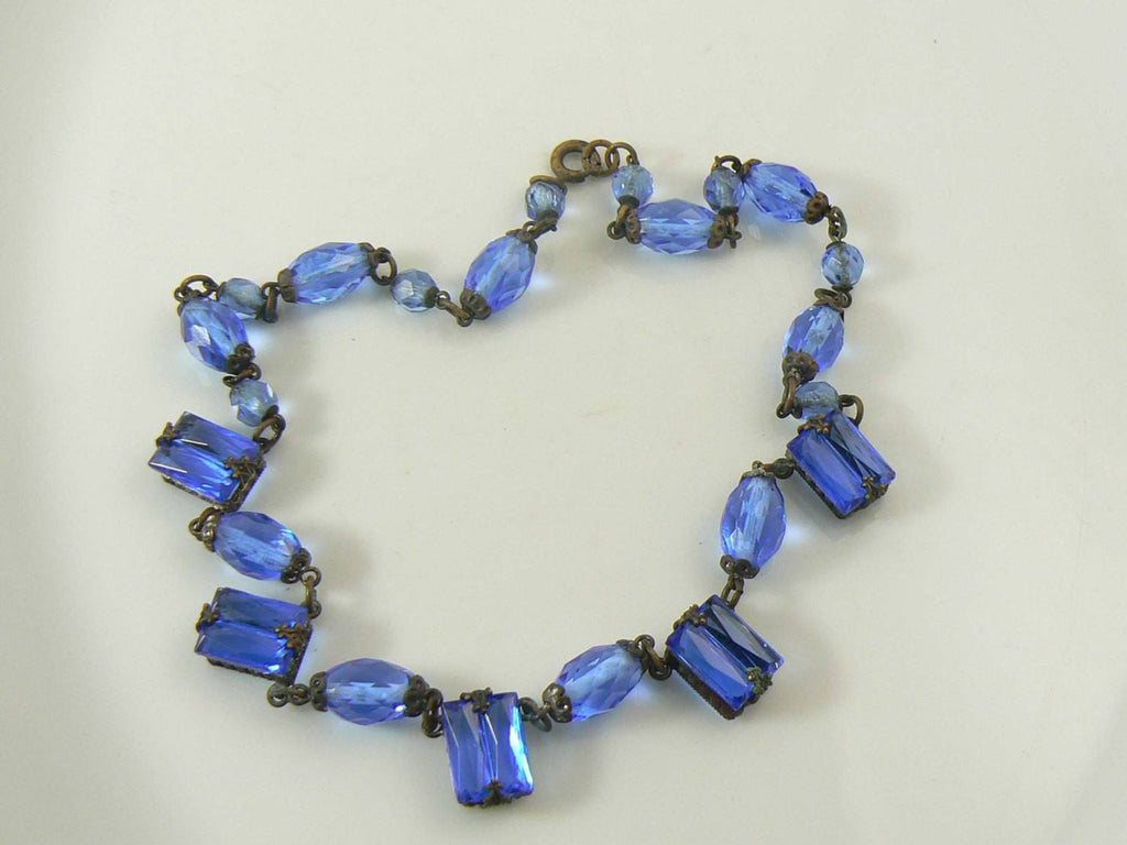 Art Deco blue step glass, brilliant cut glass and brass necklace